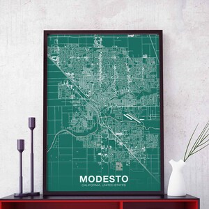 May include: A framed map of Modesto, California, with a teal background and white lines showing the city streets. The text "MODESTO, CALIFORNIA, UNITED STATES" is printed at the bottom of the map.