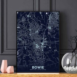 May include: A navy blue map print of Bowie, Maryland, United States. The map shows the city's streets and neighborhoods in white.