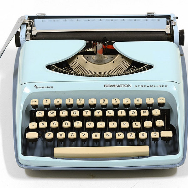 Vintage Remington Streamliner portable typewriter. Baby blue, very slim and in great condition.