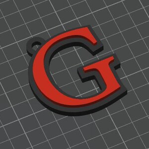 May include: A three-dimensional letter G pendant featuring a bold red face layered over a solid black base. The letter has a serif typeface design with a small circular loop at the top left corner for attachment, presented against a dark gray grid.