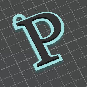 May include: A three-dimensional letter P pendant featuring a black face and a light blue border. The letter has a small circular loop at the top left corner for attachment, presented against a dark gray grid background with white lines.