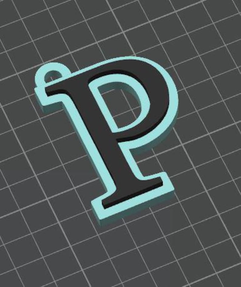 May include: A three-dimensional letter P pendant featuring a black face and a light blue border. The letter has a small circular loop at the top left corner for attachment, presented against a dark gray grid background with white lines.
