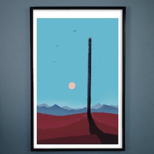 May include: Framed art print featuring a minimalist landscape. The artwork depicts a tall, dark structure against a blue sky with a setting sun. Red and purple hills are in the foreground, with mountains in the distance. Three birds are flying in the sky.