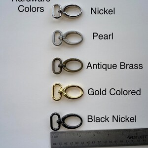 May include: Five different metal swivel clasps in various finishes: nickel, pearl, antique brass, gold colored, and black nickel. A ruler is shown for scale.