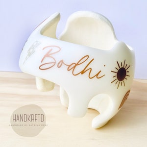 May include: White padded helmet with a gold sun, lightning bolt, and the name "Bodhi" written in gold script.