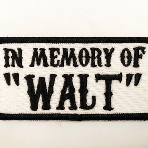 May include: White embroidered patch with black stitching. The patch reads "In Memory of "Walt""