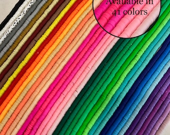 May include: A collection of 41 colorful round polymer clay beads. The beads are arranged in rows, with each row a different color. The beads are all the same size and shape.