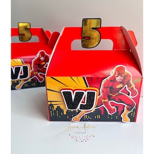 May include: Red and yellow favor box with a superhero character, the Flash, and the letters "VJ" with a black glitter finish. The box has a handle and a gold number "5" on top.