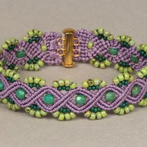 May include: A purple and green beaded bracelet with a gold clasp. The bracelet is made with a knotting technique and features green and turquoise beads.