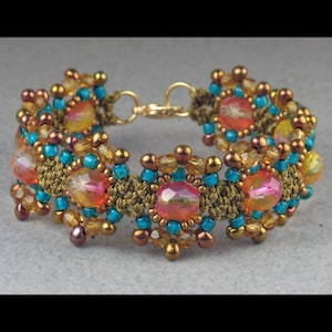 May include: A beaded bracelet with a gold clasp, featuring a repeating pattern of turquoise and gold beads surrounding larger, iridescent pink and orange beads.
