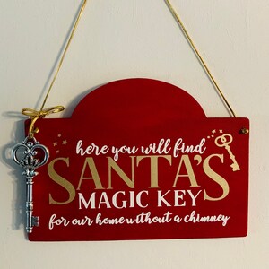 May include: A red wooden sign with a gold key and the text "here you will find SANTA'S MAGIC KEY for our home without a chimney".