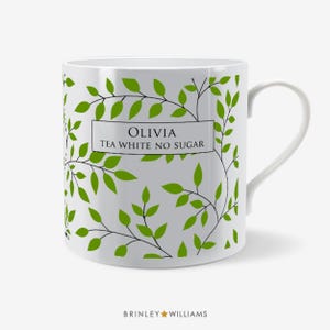 May include: White ceramic mug with a green leaf pattern and the text "Olivia Tea White No Sugar" on the front.