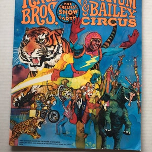 May include: A vintage Ringling Bros. and Barnum & Bailey Circus program cover. The cover features a tiger, a circus performer, and various circus acts. The text reads "Ringling Bros. and Barnum & Bailey Circus" and "The Greatest Show on Earth."