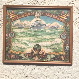 May include: A framed certificate with a nautical theme. The certificate is titled "Royal Order of Atlantic Voyageurs" and features a ship sailing on the ocean. The certificate is signed by "Neptunus Rex, Ruler of the Raging Main".