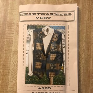 May include: A sewing pattern envelope titled HEARTWARMERS VEST #125 PATCHWORKS. The cover features a photograph of a patchwork vest made from various blue, brown, and patterned fabric squares, worn over a cream-colored turtleneck sweater.