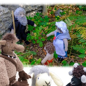 May include: Knit a Story: Nibit's Adventures knitting pattern featuring a brown knitted creature with a long nose, a gray knitted sheep, a black knitted sheep, a gray knitted woman with a white bonnet, a brown knitted man with a long beard, and a brown knitted child. The pattern is designed by Linda Moorhouse.