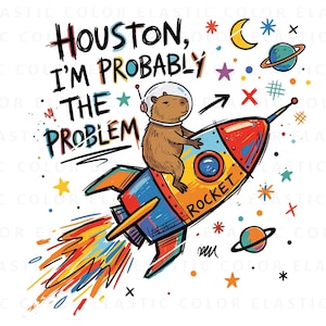 May include: A graphic illustration featuring a brown capybara wearing a space helmet and riding a colorful rocket. The text reads "HOUSTON, I'M PROBABLY THE PROBLEM" and "ROCKET" on the side. The design includes stars, planets, and a moon.