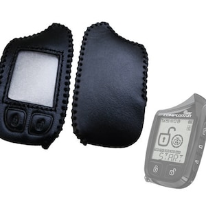 May include: Two black leather key fob covers with stitching detail. One cover has a cutout for a screen and two buttons. The other cover is solid. A black car remote with a screen displaying "COMSTAR" and "START" is shown.
