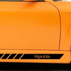 May include: Orange car with a black racing stripe and the text "Night Kids" on the side.