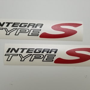 May include: Two white stickers with black text that reads "Integra Type S" and a red "S" logo.