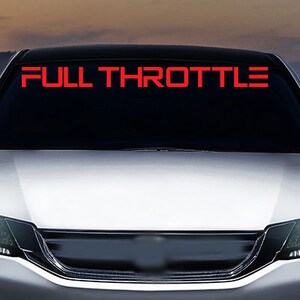 May include: A silver car with the words "FULL THROTTLE" in red letters on the windshield.