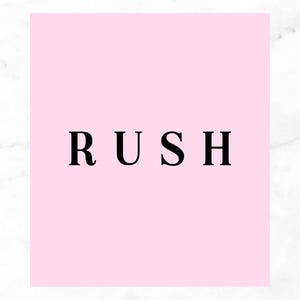 May include: A square graphic featuring a solid light pink background with the word RUSH printed in bold black capital letters in the centre. The text lolli bella is printed in small black lowercase letters in the bottom right corner.