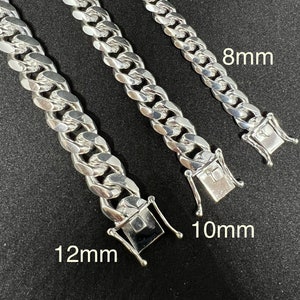 May include: Three silver curb chain necklaces with different widths. The chains are 8mm, 10mm, and 12mm wide.