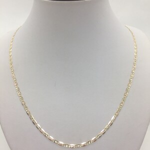 May include: A gold chain necklace with a delicate, textured design. The chain is made of 10k gold and has a lobster clasp closure.