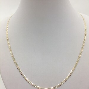 May include: A gold chain necklace with a delicate, textured design. The chain is made of 10k gold and is 18 inches long.