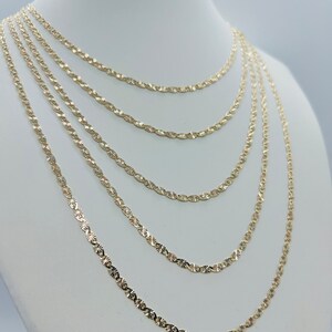 May include: Five gold chains of varying lengths, all with a diamond-cut design, displayed on a white mannequin bust.