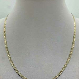 May include: A gold chain necklace with a mariner link design. The chain is on a white mannequin bust.