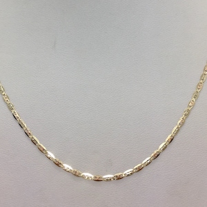 May include: A gold chain necklace with a delicate, oval-shaped link pattern.