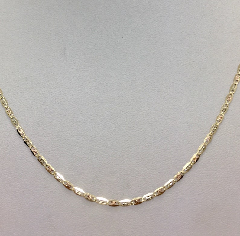 May include: A gold chain necklace with a delicate, oval-shaped link pattern.