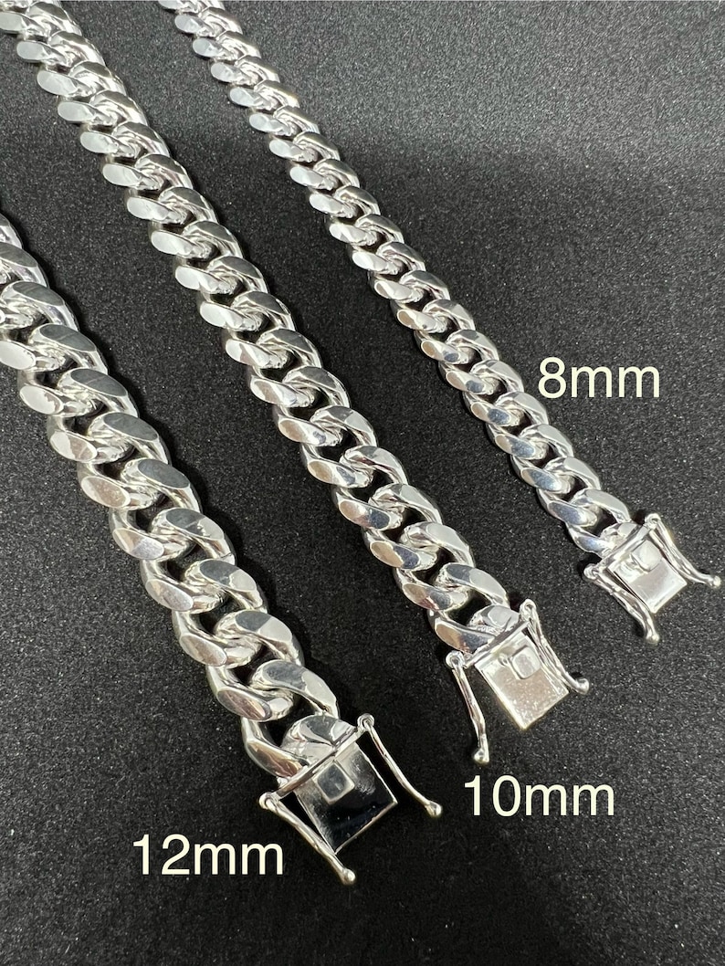 May include: Three silver curb chain necklaces with different widths. The chains are 8mm, 10mm, and 12mm wide.