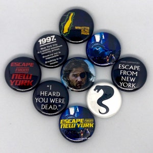 May include: Eight round buttons with various designs from the movie Escape From New York. The buttons feature a map of Manhattan Island, a quote from the movie, a snake, and a character from the movie.