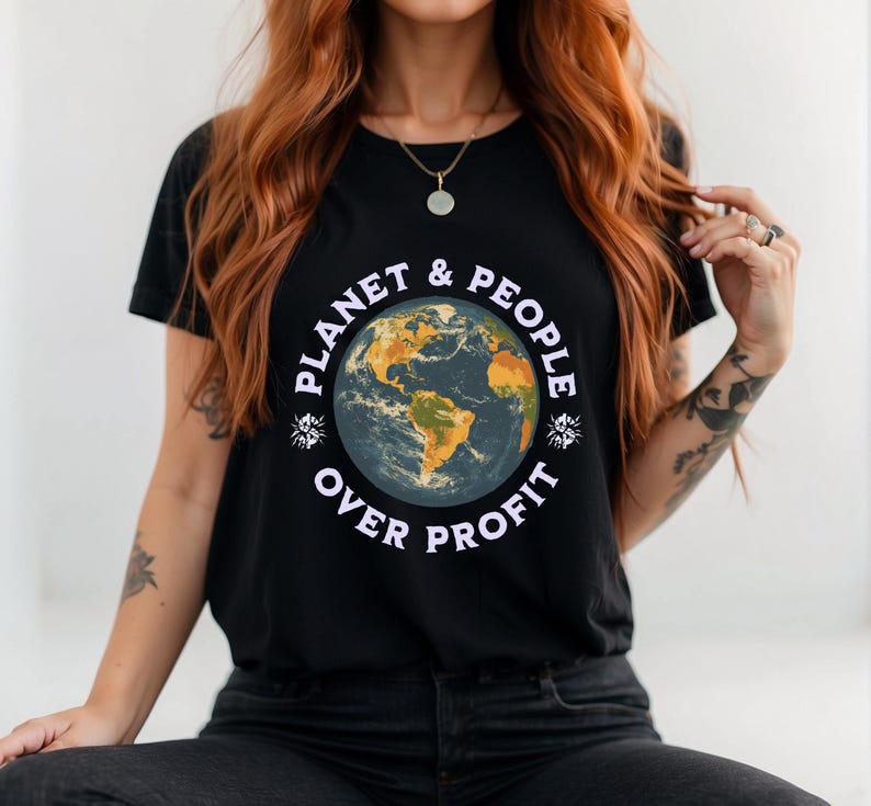 May include: Black t-shirt featuring a graphic of a blue and yellow globe with the text "Planet & People Over Profit" in white.