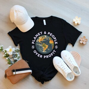 May include: Black t-shirt with a graphic of a globe and the text "Planet & People Over Profit".