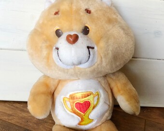 care bear with trophy on belly