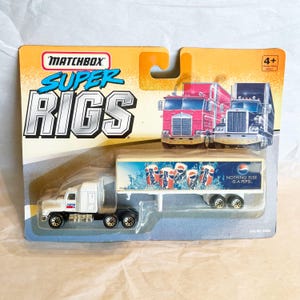 May include: Matchbox Super Rigs toy truck with a white cab and Pepsi trailer. The trailer features Pepsi cans and the text "Nothing Else Is A Pepsi." The packaging is yellow and blue.