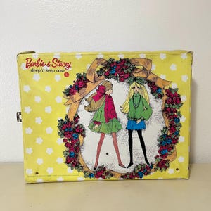 May include: A white ceramic mug with a black handle and the text "But First, Coffee" in a bold, black font. The mug is set against a neutral background, highlighting its simple design.