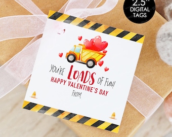May include: A Valentine's Day gift tag with a yellow dump truck carrying red heart-shaped balloons. The tag reads "You're Loads of Fun! Happy Valentine's Day From." The tag has a black and yellow striped border and is 2.5 inches in size.