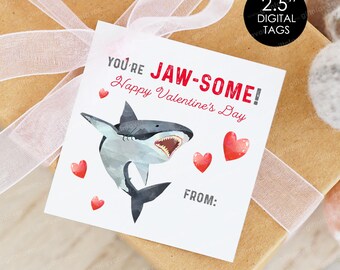 May include: A white card with a red and white shark illustration and the text "You're Jaw-Some! Happy Valentine's Day" with red hearts. The card has a blank space for "From:"