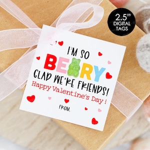 May include: A white card with a red heart border and the text "I'm so BEARY glad we're friends! Happy Valentine's Day!" with a gummy bear in the middle of the word "BEARY".