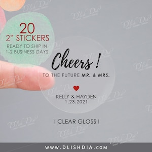May include: Twenty 2-inch clear gloss stickers with the text "Cheers! To the future Mr. & Mrs. Kelly & Hayden 1.23.2021" and a red heart.