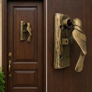 May include: A bronze-toned metal door knocker shaped like a bird perched on a textured rectangular base. The knocker is mounted on a dark brown wooden door, which also features a separate brass-colored door handle and a circular keyhole plate.