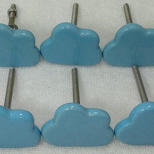 Pode incluir: Dez puxadores de arm&aacute;rio em forma de nuvem azul claro com hastes e ferragens de metal prateado. Os puxadores est&atilde;o dispostos em duas filas de cinco, mostrando um design caprichoso. Estes puxadores decorativos s&atilde;o adequados para gavetas e arm&aacute;rios.
