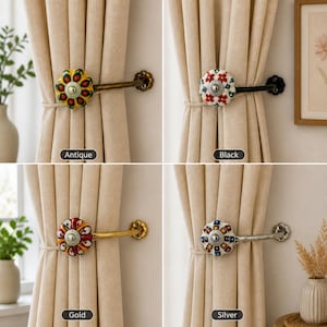 May include: Four curtain tiebacks featuring decorative ceramic knobs with floral patterns in various colors. The hardware finishes include antique, black, gold, and silver metal arms that secure the beige curtains to the wall.
