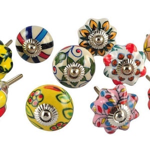 May include: Ten colorful ceramic cabinet knobs with different floral and geometric patterns. The knobs are round and have a silver metal base.