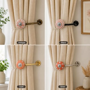 May include: Four curtain tiebacks with round ceramic knobs in orange and white patterns. The hardware finishes include antique, black, gold, and silver metal arms. Each knob features a central silver-toned circular detail and a floral or polka dot design.