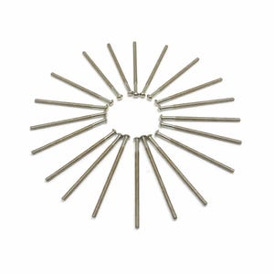 May include: A circular arrangement of silver machine screws on a white backdrop. Each screw features a threaded shaft and a rounded head. The screws are evenly spaced, forming a radial pattern, commonly used in engineering and construction.